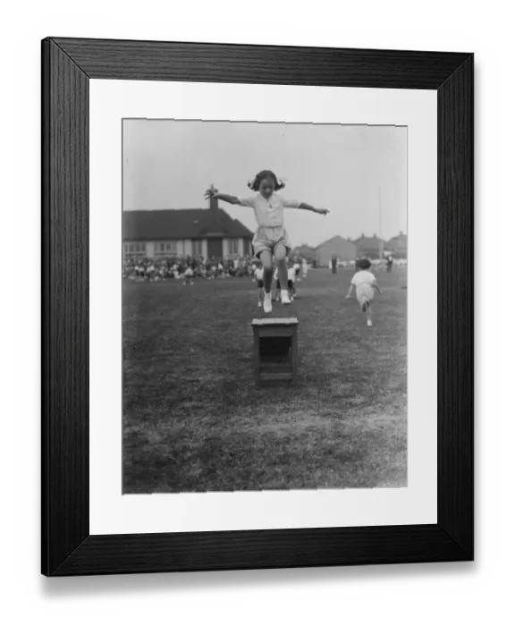 Framed Print : Sports day at the Days Lane Infant School in Sidcup, Kent. A little girl jumps
