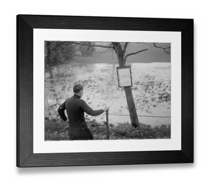 Framed Print : A boy looks at the flooded Sidcup swimming pool - flooded due to the bad weather