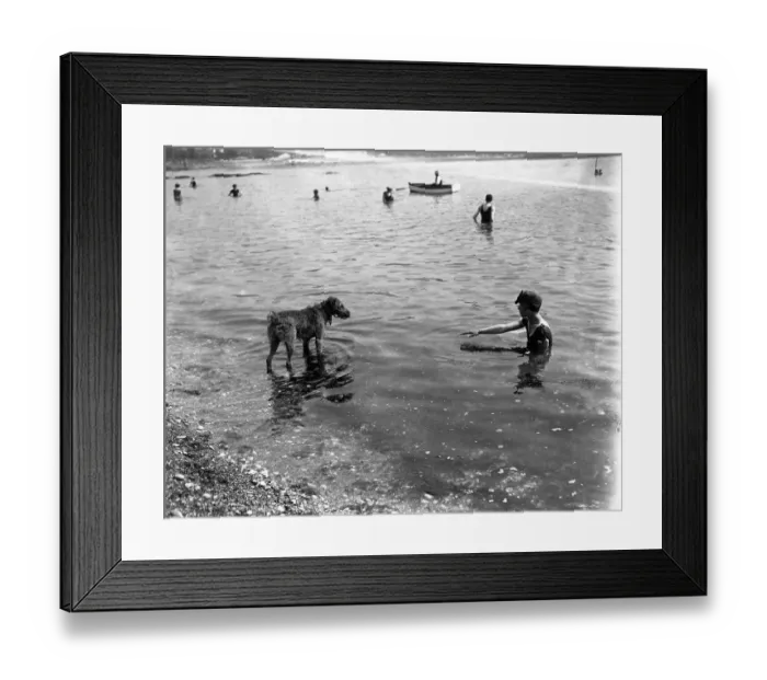 Framed Print : Bathing scenes at Torquay, Devon. A young swimmer and her dog