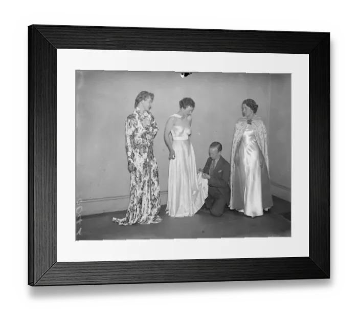 Framed Print : A student arranging the gowns on models for the display Exquisite gowns, designed by past Framed Print : A student arranging the gowns on models for the display Exquisite gowns, designed by past