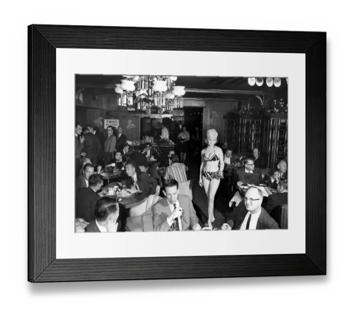 Framed Print : A scanty clad waitress is the high light attracting the attentions of a male audience Framed Print : A scanty clad waitress is the high light attracting the attentions of a male audience
