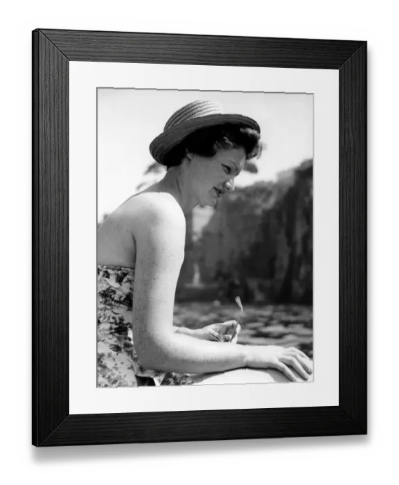 Framed Print : A young woman in a strapless dress enjoys the summer sunshine