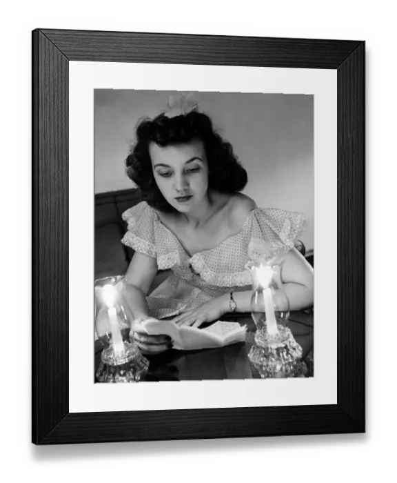 Framed Print : Young woman reading a letter by candlelight from her sweetheart in the American Forces in England Framed Print : Young woman reading a letter by candlelight from her sweetheart in the American Forces in England