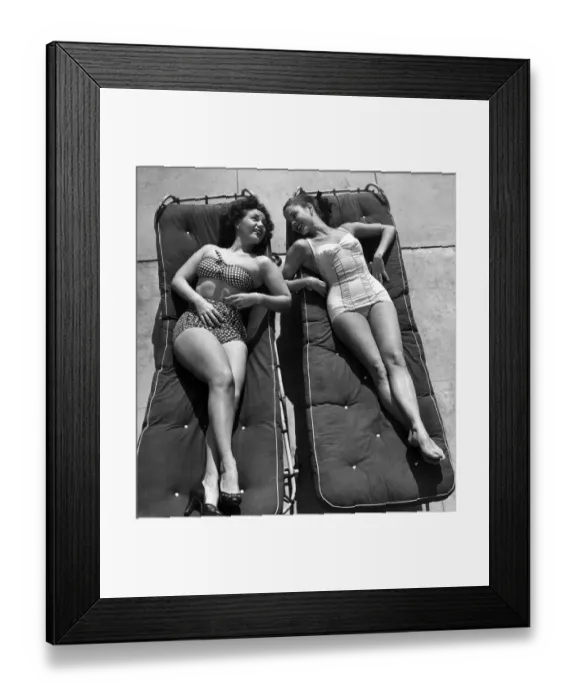 Framed Print : Women sunbathing lying on sunbeds Framed Print : Women sunbathing lying on sunbeds