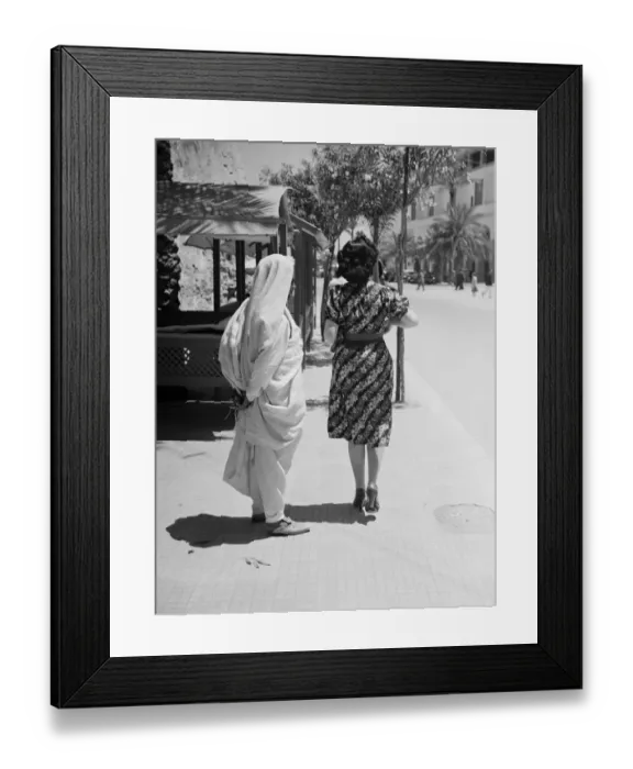 Framed Print : Tripoli. Contrast in fashion, and native Arab and a modern Italian girl