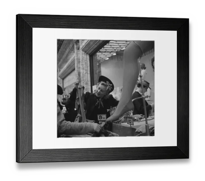 Framed Print : Day in the life of a Midinette. A Parisian salesgirl out shopping for some silk stockings