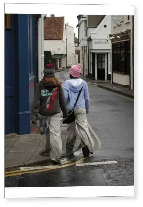 Print : Young fashion: two teenage girls wearing baggy trousers that drag on the ground and get dirty Print : Young fashion: two teenage girls wearing baggy trousers that drag on the ground and get dirty