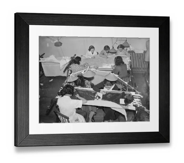 Framed Print : Embroiders at Hartnells, the Court dressmakers, are at work in London on exquisite
