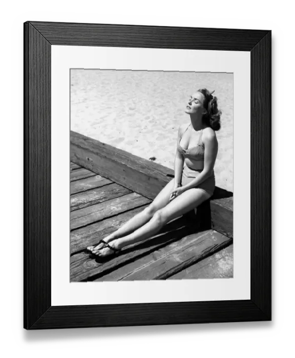 Framed Print : A young lady wearing a bikini and sandals sunbathing Framed Print : A young lady wearing a bikini and sandals sunbathing