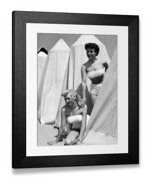 Framed Print : Two women next with changing huts Framed Print : Two women next with changing huts
