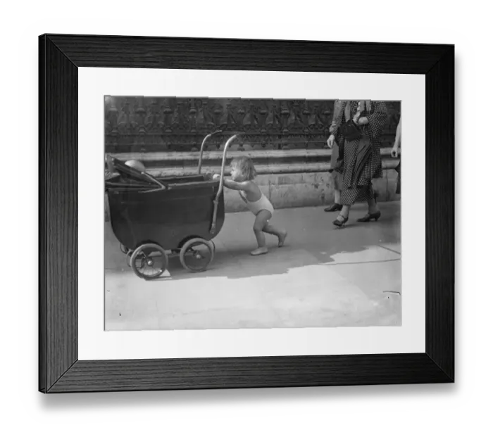 Framed Print : Piccadilly heat wave parade. In the briefest of bathing costumes this little girl Framed Print : Piccadilly heat wave parade. In the briefest of bathing costumes this little girl