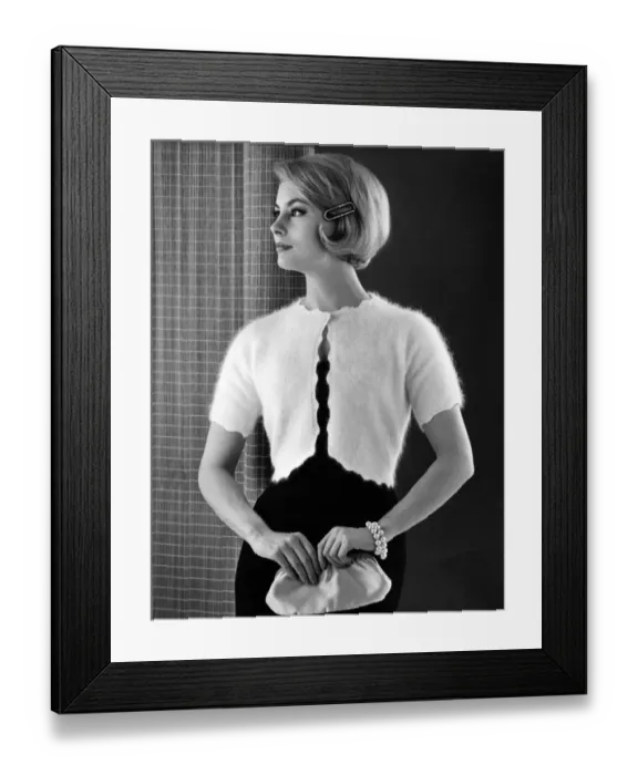 Framed Print : Woman models an angora knitted bolero top over a black party dress, in her hair Framed Print : Woman models an angora knitted bolero top over a black party dress, in her hair