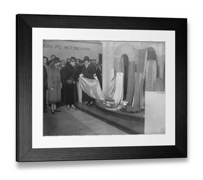 Framed Print : Queen watches fashion parade at British textile exhibition. The Queen, accompanied