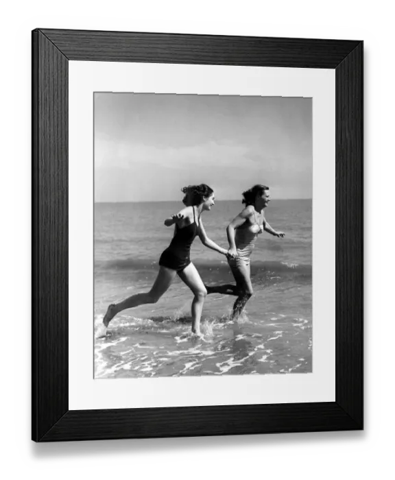 Framed Print : The sun comes to greet these two fair holiday makers, and they run to meet it half way