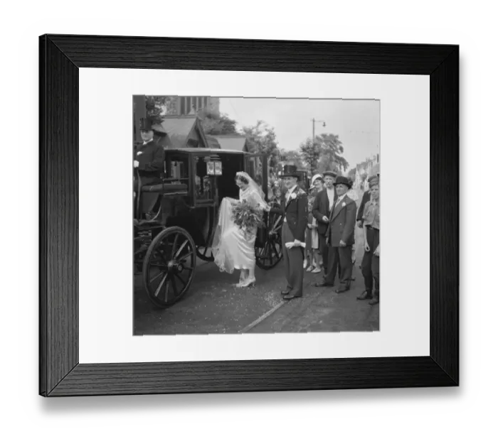 Framed Print : An old fashion wedding at Eltham Parish church. The bride climbing onto the horse