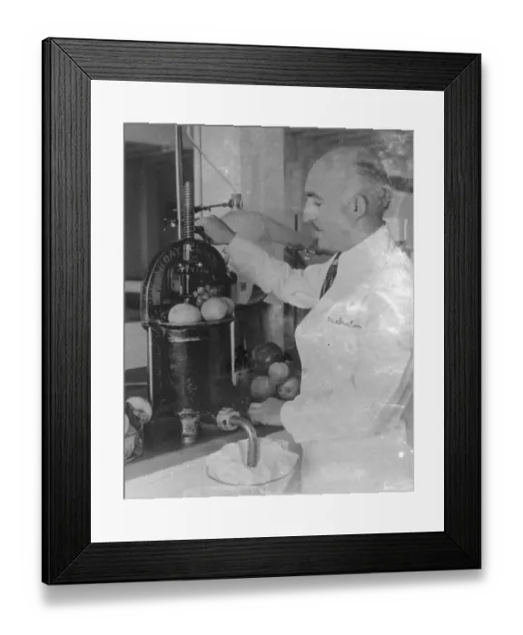 Framed Print : Dr A T Frascati an American scientist. Making perfume from crushed fruit. Photo shows Framed Print : Dr A T Frascati an American scientist. Making perfume from crushed fruit. Photo shows
