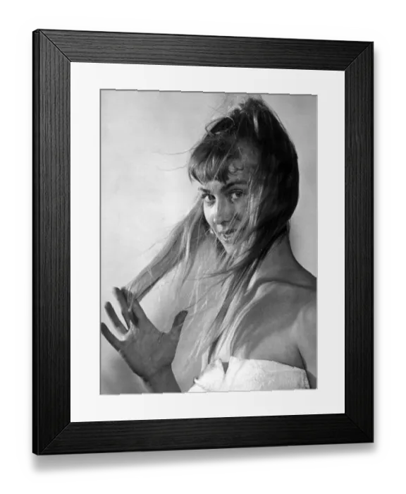 Framed Print : A woman with long hair looking at the camera 1960s