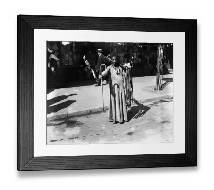 Framed Print : A man selling walking sticks on the streets of Cairo, Egypt. 21 March 1923 Framed Print : A man selling walking sticks on the streets of Cairo, Egypt. 21 March 1923