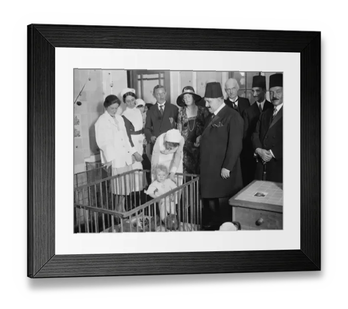 Framed Print : King Fuad at the Royal Free Hospital. A little patient who presented King Fuad with his doll