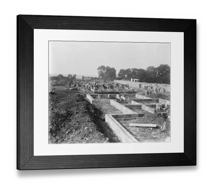 Framed Print : Building a concrete village at Braintree, Essex In the foreground a new foundation setting