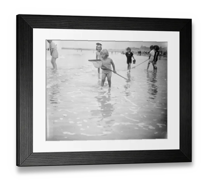 Framed Print : The look of wonder. A little shrimper on the coast of Normandy looks with wondering Framed Print : The look of wonder. A little shrimper on the coast of Normandy looks with wondering