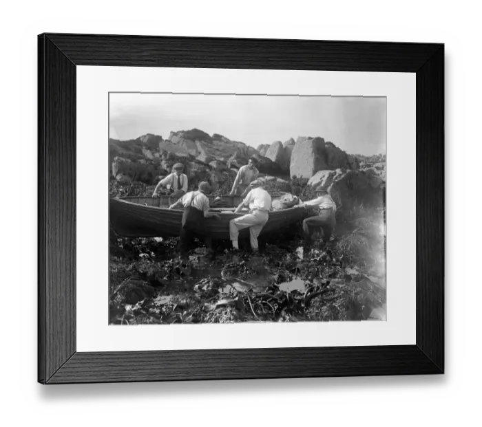 Framed Print : Channel Islanders trying to refloat their boat off the rocky seashore after gathering Framed Print : Channel Islanders trying to refloat their boat off the rocky seashore after gathering