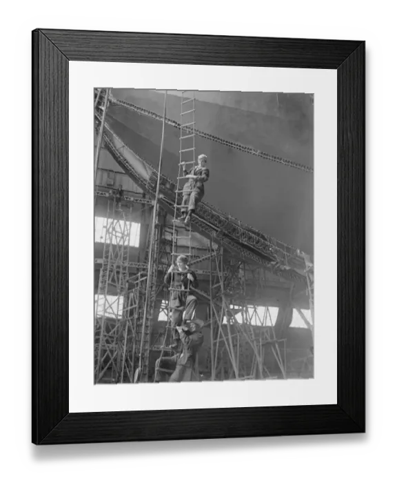 Framed Print : Worlds largest airship for the United States Girl workers on the airship climbing Framed Print : Worlds largest airship for the United States Girl workers on the airship climbing