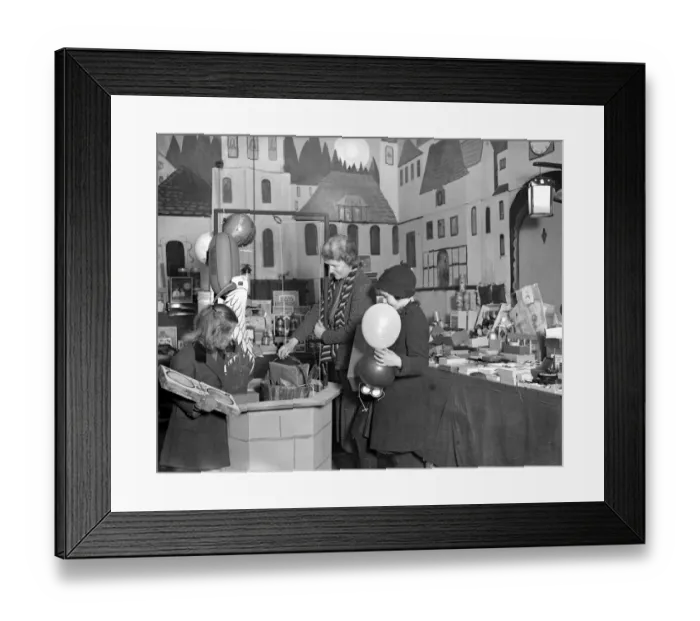 Framed Print : Lady Verney (striped scarf) in the toy and bookshop she has opened in the garage Framed Print : Lady Verney (striped scarf) in the toy and bookshop she has opened in the garage
