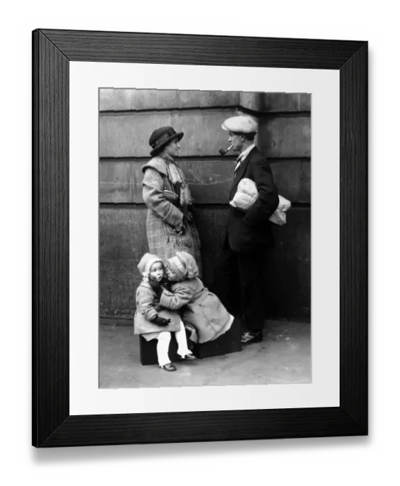 Framed Print : A couple chatting while their children are kissing under the mistletoe 25 December 1921 Framed Print : A couple chatting while their children are kissing under the mistletoe 25 December 1921