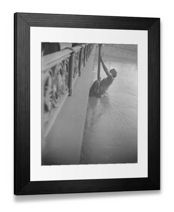 Framed Print : Escaping from the floods. The huge bronze figure on the Pont Mirabeau would Framed Print : Escaping from the floods. The huge bronze figure on the Pont Mirabeau would