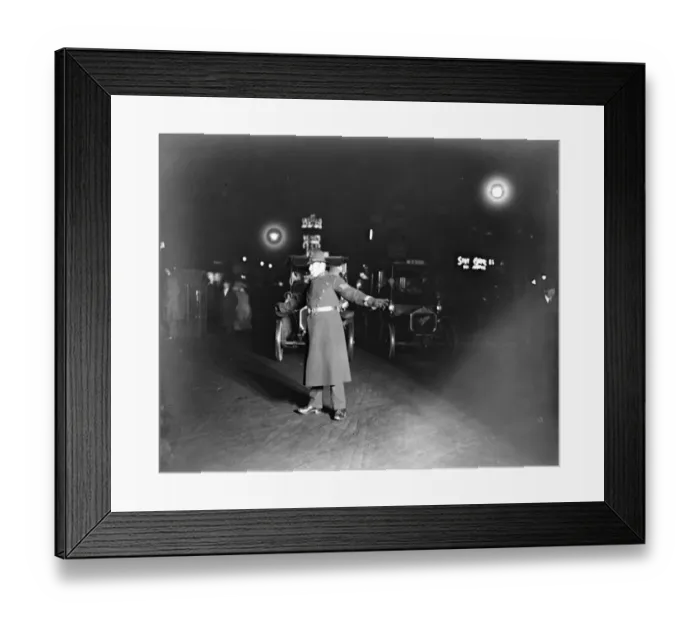 Framed Print : A police officer directing traffic at night in London 12 December 1921 Framed Print : A police officer directing traffic at night in London 12 December 1921
