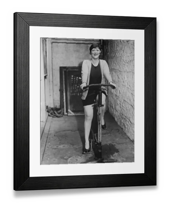 Framed Print : Noted Opera star strikes a new note. Frieda Hempel, exercising on a cycling machine Framed Print : Noted Opera star strikes a new note. Frieda Hempel, exercising on a cycling machine