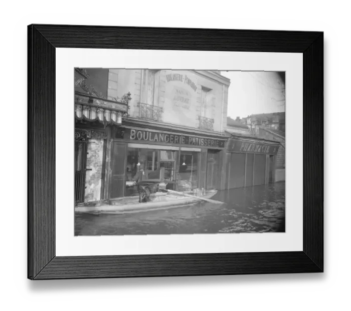 Framed Print : Paris and its suburbs under water. A baker removing his goods from his shop which Framed Print : Paris and its suburbs under water. A baker removing his goods from his shop which