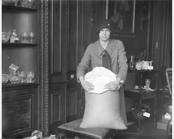 Miss Marjorie Pollock ( daughter of Sir Ernest and Lady Pollock ) with the sack of