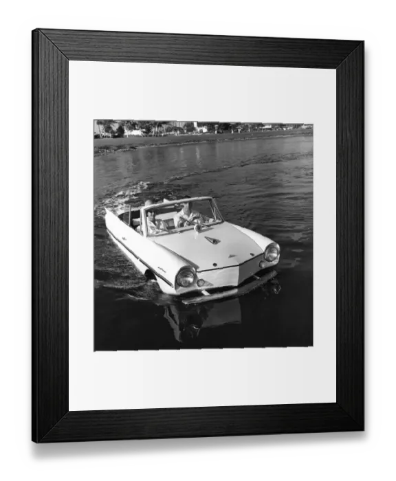 Framed Print : The Youngs cruise along in the lake. The entire body of the amphicar floats on both longitudinal Framed Print : The Youngs cruise along in the lake. The entire body of the amphicar floats on both longitudinal