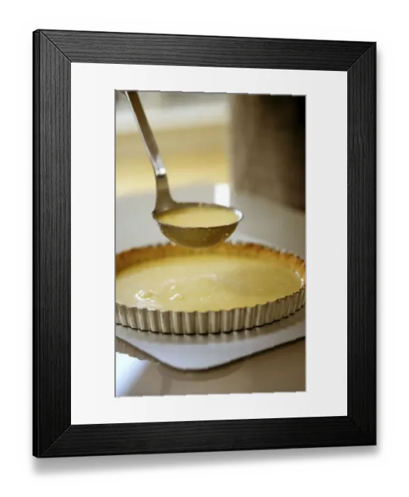 Framed Print : Spooning lemon mixture into pastry case sitting on baking sheet, to minimise spillage Framed Print : Spooning lemon mixture into pastry case sitting on baking sheet, to minimise spillage