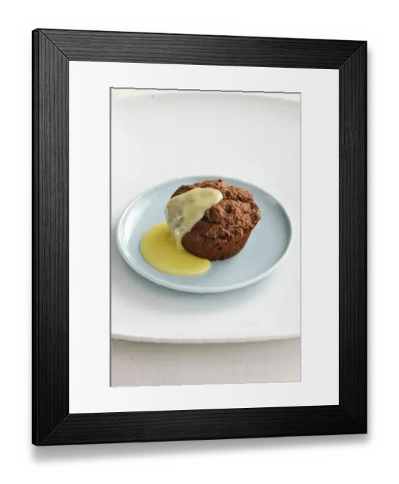Framed Print : Warm chocolate muffin served as a dessert with custard sauce credit: Marie-Louise Framed Print : Warm chocolate muffin served as a dessert with custard sauce credit: Marie-Louise