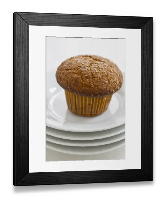 Framed Print : Cinnamon bran muffin on stack of white plates with cup of black coffee credit Framed Print : Cinnamon bran muffin on stack of white plates with cup of black coffee credit