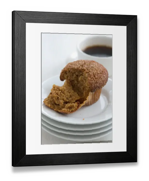 Framed Print : Cinnamon bran muffin on stack of white plates with cup of black coffee credit Framed Print : Cinnamon bran muffin on stack of white plates with cup of black coffee credit