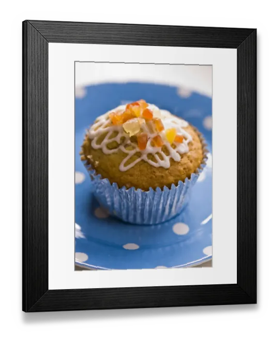 Framed Print : Muffin decorated with squiggly icing and candied peel on spotted blue plate credit Framed Print : Muffin decorated with squiggly icing and candied peel on spotted blue plate credit