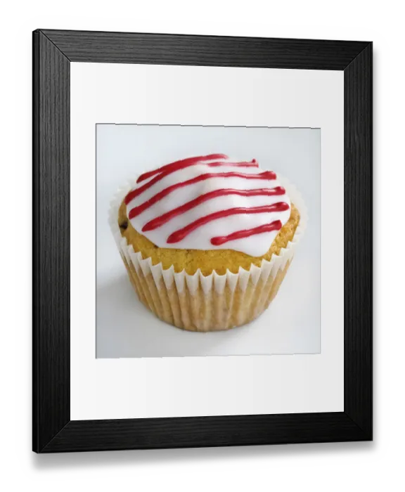 Framed Print : Iced cupcake with red stripes on white icing credit: Marie-Louise Avery / thePictureKitchen Framed Print : Iced cupcake with red stripes on white icing credit: Marie-Louise Avery / thePictureKitchen