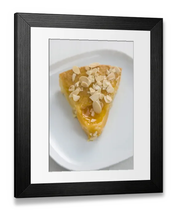 Framed Print : Slice of peach cake / tart sprinkled with flaked almonds credit: Marie-Louise Avery Framed Print : Slice of peach cake / tart sprinkled with flaked almonds credit: Marie-Louise Avery