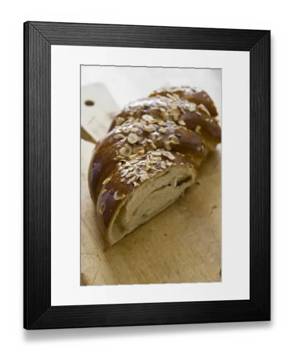 Framed Print : Piece of sweet, yeast bread with almonds and almond paste on wooden board credit Framed Print : Piece of sweet, yeast bread with almonds and almond paste on wooden board credit