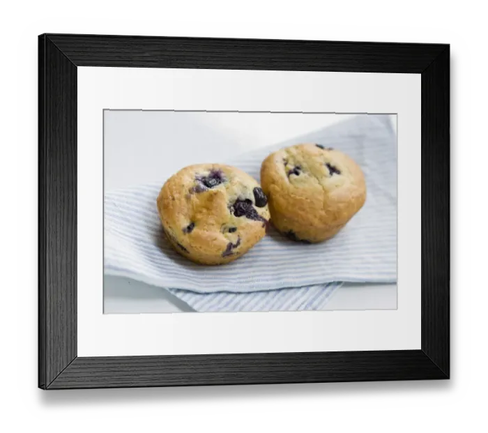 Framed Print : Freshly baked blueberry muffin on blue striped napkin. credit: Marie-Louise Avery Framed Print : Freshly baked blueberry muffin on blue striped napkin. credit: Marie-Louise Avery