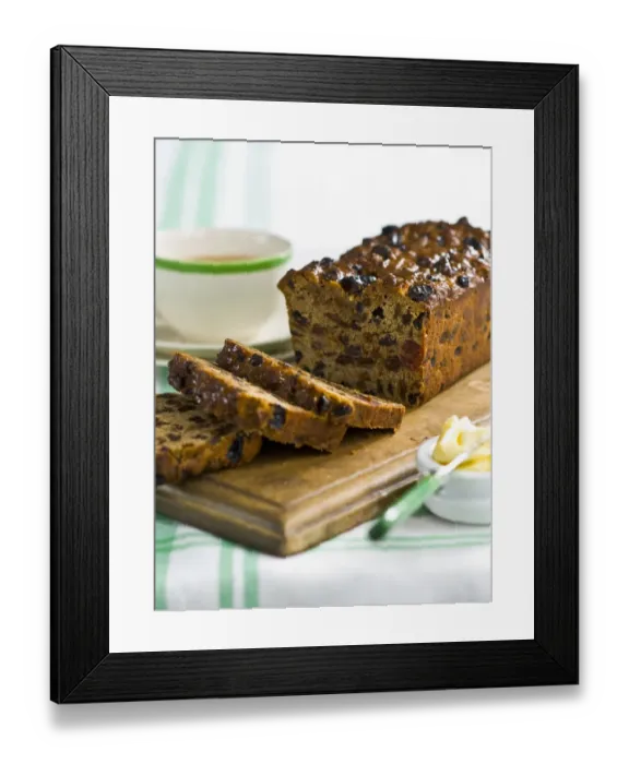 Framed Print : Traditional style fruit tea loaf sliced and served with butter and afternoon tea credit Framed Print : Traditional style fruit tea loaf sliced and served with butter and afternoon tea credit