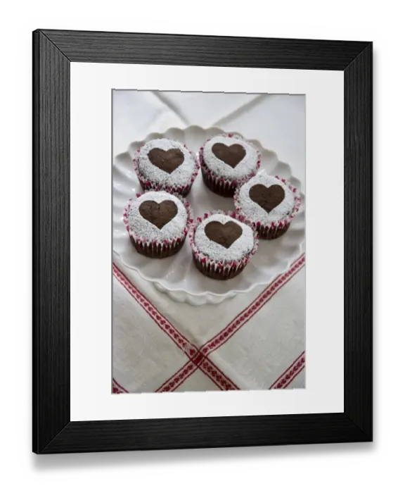 Framed Print : Five chocolate muffins decorated with icing sugar in heart shape on white cake stand credit