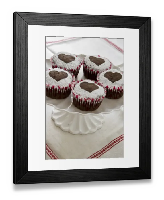 Framed Print : Five chocolate muffins decorated with icing sugar in heart shape on white cake stand credit