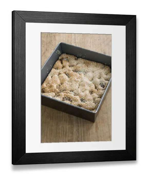 Framed Print : Semolina cake with figs and sesame still in its square tray on the kitchen table credit Framed Print : Semolina cake with figs and sesame still in its square tray on the kitchen table credit