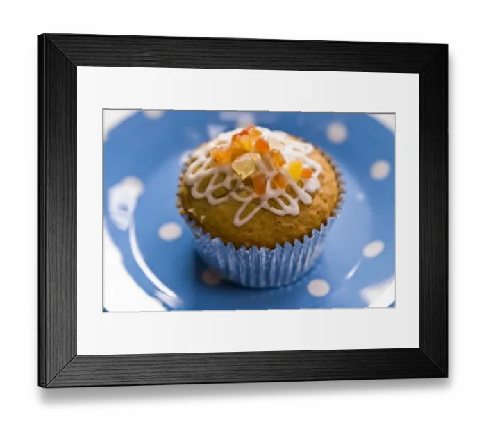 Framed Print : Muffin decorated with squiggly icing and candied peel on spotted blue plate credit Framed Print : Muffin decorated with squiggly icing and candied peel on spotted blue plate credit