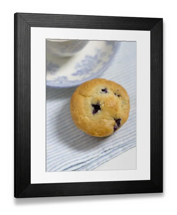 Framed Print : Freshly baked blueberry muffin on blue striped napkin with blue and white china credit Framed Print : Freshly baked blueberry muffin on blue striped napkin with blue and white china credit